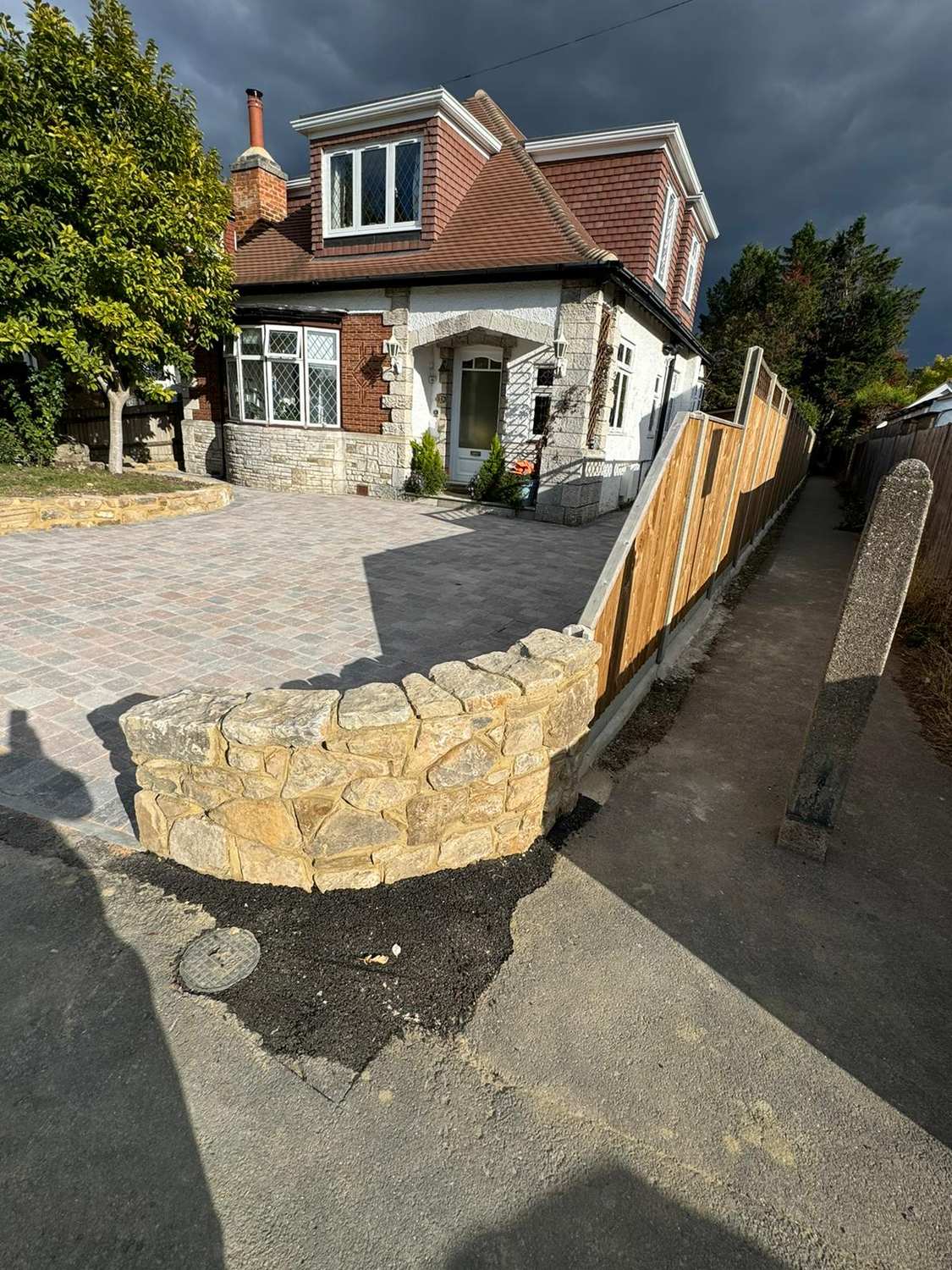 Block paving and stone wall